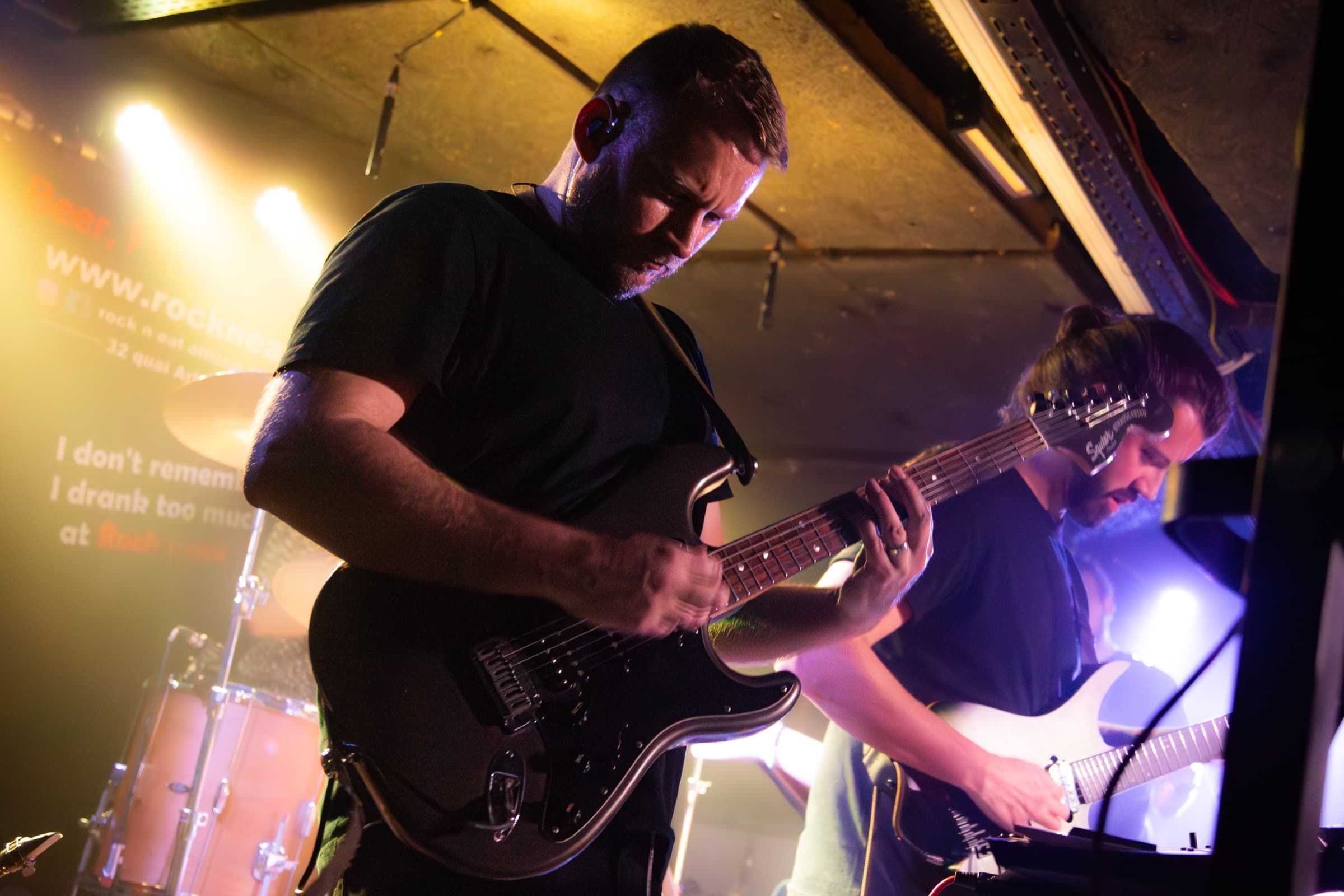Tom Doesburg and Vincent Chaudière performing under warm stage lights.