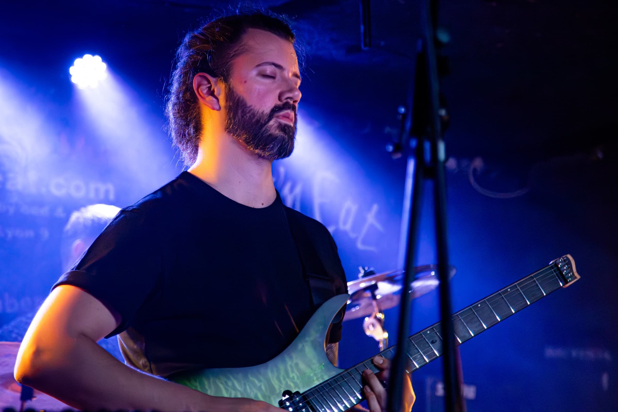 Vincent Chaudière with eyes closed under blue light.
