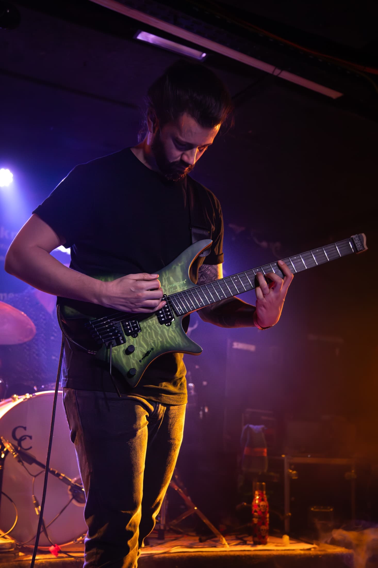 Vincent Chaudière playing a green guitar on stage.